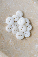 Another close-up view of the buttons on the marbled beige stone, from a different angle.