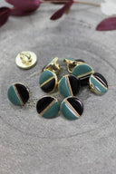 Close-up of the same two-tone buttons, highlighting the gold trim separating the two colors.