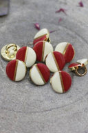Close-up of the same two-tone buttons, highlighting the gold trim separating the two colors.