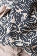 Close-up of the folded Petal fabric in navy, showing the detail of the interlocking-circles pattern in off-white.