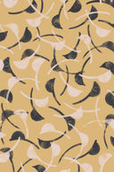 Flat-lay of the Windy fabric in mustard, with a repeating curved-leaf pattern in navy and off-white on a mustard background.