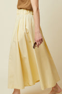 Vertigo Skirt pattern – profile view, skirt flared yellow colourway, full length – Atelier Brunette