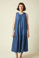 Flare Dress pattern – Front view, dress loose-fitting denim blue, gathered neckline, ruffled skirt, midi length – Atelier Brunette
