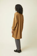 Troublante Jacket pattern – back view, colourway caramel, grey jeans and black ankle boots – Atelier Brunette