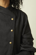 Troublante Jacket pattern – front bust view, crossed stand collar and gold button fastening, colourway black – Atelier Brunette