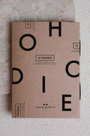 Hoodie pattern – kraft pattern envelope with collection name print, set against a textured wall – Atelier Brunette