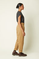Belted Trousers pattern – Profile view, carrot trousers camel high waist, top sleeveless grey – Atelier Brunette