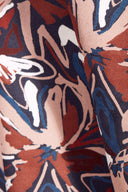 Close-up of the navy, terracotta and blue graphic floral print on the Hilma River viscose fabric.