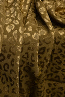 Close-up of the golden khaki Leony jacquard fabric, detailing the raised woven leopard pattern and the satiny finish of the yarn.