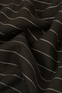 La Rayure 002 charcoal fabric with fine ecru stripes, folded flat, showing the woven selvedge.
