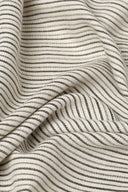 La Rayure 005 mottled ecru fabric with fine dotted charcoal horizontal stripes, folded flat.