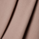 Diagonal close-up on the fine ribs of the powder pink ribbing, stretch knit texture.