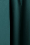 Pine green cotton poplin fabric falling in vertical folds, highlighting its soft drape.